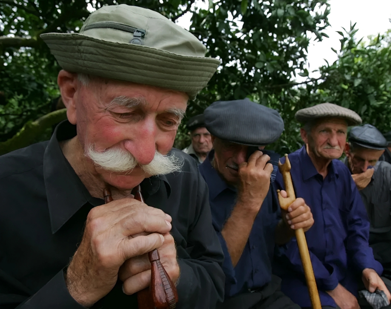 Men cry during the funeral of an Abkhaz soldier who was killed in the remote Kodor after an armed clash with Georgians. August 16, 2008.